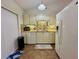 Efficient kitchen with white appliances, lots of storage, and modern flooring at 318 Douglas Way # 87, Winter Garden, FL 34787