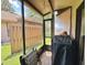Screened porch featuring a grill, outdoor seating, and a view of the backyard, perfect for outdoor dining at 318 Douglas Way # 87, Winter Garden, FL 34787
