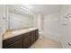 Bright bathroom features double vanity, tile flooring, and tub shower at 3666 Maidencain St, Clermont, FL 34714