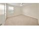 Bright bedroom features neutral carpet, ceiling fan, and a window at 3666 Maidencain St, Clermont, FL 34714