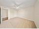 Neutral bedroom features neutral carpet, white walls, and ceiling fan at 3666 Maidencain St, Clermont, FL 34714