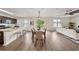 Open-concept dining area featuring wood floors, modern lighting, and sliding door access at 3666 Maidencain St, Clermont, FL 34714