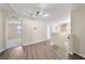 Hallway with wood floors, neutral paint, and multiple rooms off of the main hallway at 3666 Maidencain St, Clermont, FL 34714