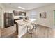Stylish kitchen featuring stainless steel appliances, granite countertops, and a breakfast bar with seating at 3666 Maidencain St, Clermont, FL 34714