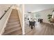 Living room with a staircase, wood floors, and large windows providing lots of light at 3666 Maidencain St, Clermont, FL 34714