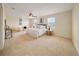 Main bedroom featuring carpet, a ceiling fan, and large windows, providing lots of light at 3666 Maidencain St, Clermont, FL 34714