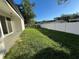 Spacious backyard with a lush lawn and secure white fence, ideal for outdoor activities and privacy at 3764 Rachel St, Apopka, FL 32703