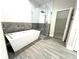 Spa-like bathroom features freestanding tub, glass shower, and wood-look tile flooring at 3764 Rachel St, Apopka, FL 32703