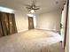 Spacious bedroom with neutral carpeting, ceiling fan, and elegant draperies at 3764 Rachel St, Apopka, FL 32703