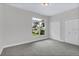 Spacious bedroom with a large window and double closet doors, offering ample natural light at 3764 Rachel St, Apopka, FL 32703