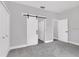 Bedroom featuring carpeted floors, barn door closet, and a traditional closet on the side at 3764 Rachel St, Apopka, FL 32703