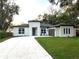 Contemporary single-story home featuring clean lines, modern windows, a spacious driveway, and well-manicured lawn at 3764 Rachel St, Apopka, FL 32703