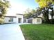 Contemporary home boasting a well-manicured lawn and an extra long driveway at 3764 Rachel St, Apopka, FL 32703