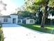 Stunning home exterior featuring modern design, mature trees, and well-manicured lawn at 3764 Rachel St, Apopka, FL 32703
