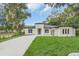 Newly built home featuring fresh landscaping, modern architectural design, and a long driveway leading to the garage at 3764 Rachel St, Apopka, FL 32703