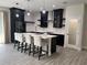 Kitchen island with seating complements the stainless appliances, dark cabinets, and modern design at 3764 Rachel St, Apopka, FL 32703