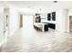 Spacious living room boasts sleek wood-look floors and abundant natural light flowing into the connected kitchen at 3764 Rachel St, Apopka, FL 32703