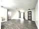 Bright, open living room with wood-look tile flooring, modern ceiling fan, and stylish front door at 3764 Rachel St, Apopka, FL 32703