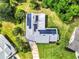 Stunning aerial view of a home with solar panels surrounded by a lush green yard at 381 Red Mulberry Ct, Longwood, FL 32779