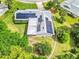Aerial view of home featuring solar panels, lush greenery, and a well-maintained yard at 381 Red Mulberry Ct, Longwood, FL 32779