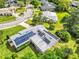 Aerial view of a house with solar panels and a lush yard in a tree-filled neighborhood at 381 Red Mulberry Ct, Longwood, FL 32779