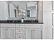 Bathroom featuring dual vanity with granite countertop, white cabinets, and stylish fixtures at 381 Red Mulberry Ct, Longwood, FL 32779