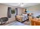 Cozy bedroom with natural light, ceiling fan, and wood-look floors at 381 Red Mulberry Ct, Longwood, FL 32779