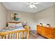 Bright bedroom features ceiling fan, natural light, and wood-look floors at 381 Red Mulberry Ct, Longwood, FL 32779