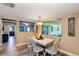 Inviting dining area with a farmhouse-style table, natural light, and open access to other living spaces at 381 Red Mulberry Ct, Longwood, FL 32779