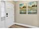 This entryway features freshly painted walls and trim and wood look floors at 381 Red Mulberry Ct, Longwood, FL 32779
