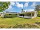 The home features solar panels, a screened-in porch, and a spacious, well-manicured backyard at 381 Red Mulberry Ct, Longwood, FL 32779