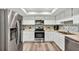 Bright kitchen featuring stainless steel appliances, white cabinetry, and a stylish backsplash for a modern look at 381 Red Mulberry Ct, Longwood, FL 32779