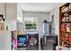 Well-lit laundry room with modern washer and dryer units and storage shelves and a hot water heater at 381 Red Mulberry Ct, Longwood, FL 32779