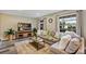 Inviting living room showcases a plush couch, updated flooring, and abundant natural light at 381 Red Mulberry Ct, Longwood, FL 32779