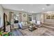 Bright living room with a comfortable sectional sofa, stylish rug, and large windows offering ample natural light at 381 Red Mulberry Ct, Longwood, FL 32779