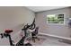 Office space with a Peloton bike, desk, and window providing natural light at 381 Red Mulberry Ct, Longwood, FL 32779