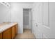 Well-lit bathroom features a double sink vanity with wood cabinets and tiled floor at 4951 Alita Ter, St Cloud, FL 34769