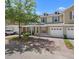 Inviting townhouse featuring a one-car garage, manicured lawn, and charming facade with brick driveway at 4951 Alita Ter, St Cloud, FL 34769