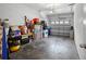 Spacious two car garage with white walls and concrete floor, filled with storage items at 4951 Alita Ter, St Cloud, FL 34769