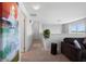 Upstairs hallway featuring neutral carpeting, natural lighting, and a cozy seating area at 4951 Alita Ter, St Cloud, FL 34769