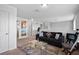 Bright loft area featuring a comfortable black sofa, plush throw pillows, and a glass coffee table at 4951 Alita Ter, St Cloud, FL 34769