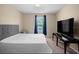 Comfortable bedroom features neutral decor and ample natural light from the window at 4951 Alita Ter, St Cloud, FL 34769