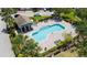 Aerial view of the community pool surrounded by lounge chairs and lush landscaping at 4951 Alita Ter, St Cloud, FL 34769
