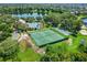 Scenic aerial view of the community showcasing the pool, tennis courts, playground, lake, and surrounding homes at 5044 Wise Bird Dr, Windermere, FL 34786