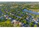 Aerial view of a neighborhood with lush greenery, a lake, and a green pin marking the property at 5044 Wise Bird Dr, Windermere, FL 34786