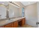 Bathroom featuring double sinks, soaking tub, large mirror, and vanity lighting at 5044 Wise Bird Dr, Windermere, FL 34786