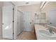 Bright bathroom featuring a double vanity, glass shower, and neutral finishes at 5044 Wise Bird Dr, Windermere, FL 34786