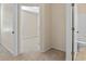 Bedroom hallway view leading to ensuite bathroom and a bedroom with neutral carpet at 5044 Wise Bird Dr, Windermere, FL 34786