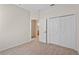 Bedroom with closet, ensuite bath access and neutral color carpeting at 5044 Wise Bird Dr, Windermere, FL 34786