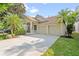 Inviting home featuring a two-car garage, manicured landscaping, and a charming front porch at 5044 Wise Bird Dr, Windermere, FL 34786